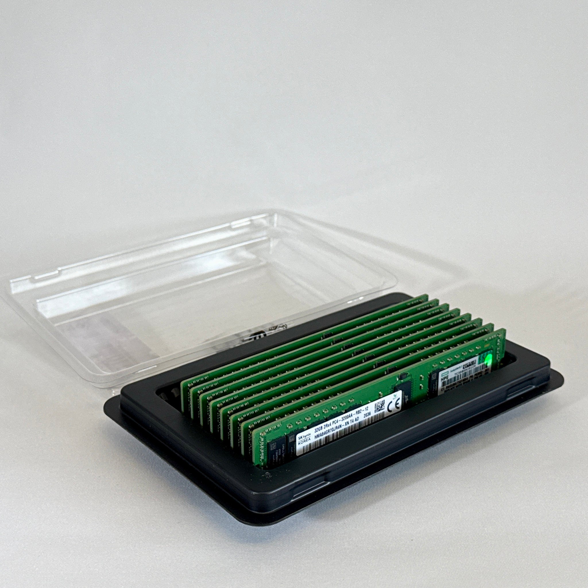 Front view of an SK Hynix 32GB 2Rx4 PC4-32AA DDR4 Registered ECC server memory stick. The green PCB holds the black memory chips and a clear white manufacturer label displaying the part number HMA84GR7DJR4N-XN and specifications.