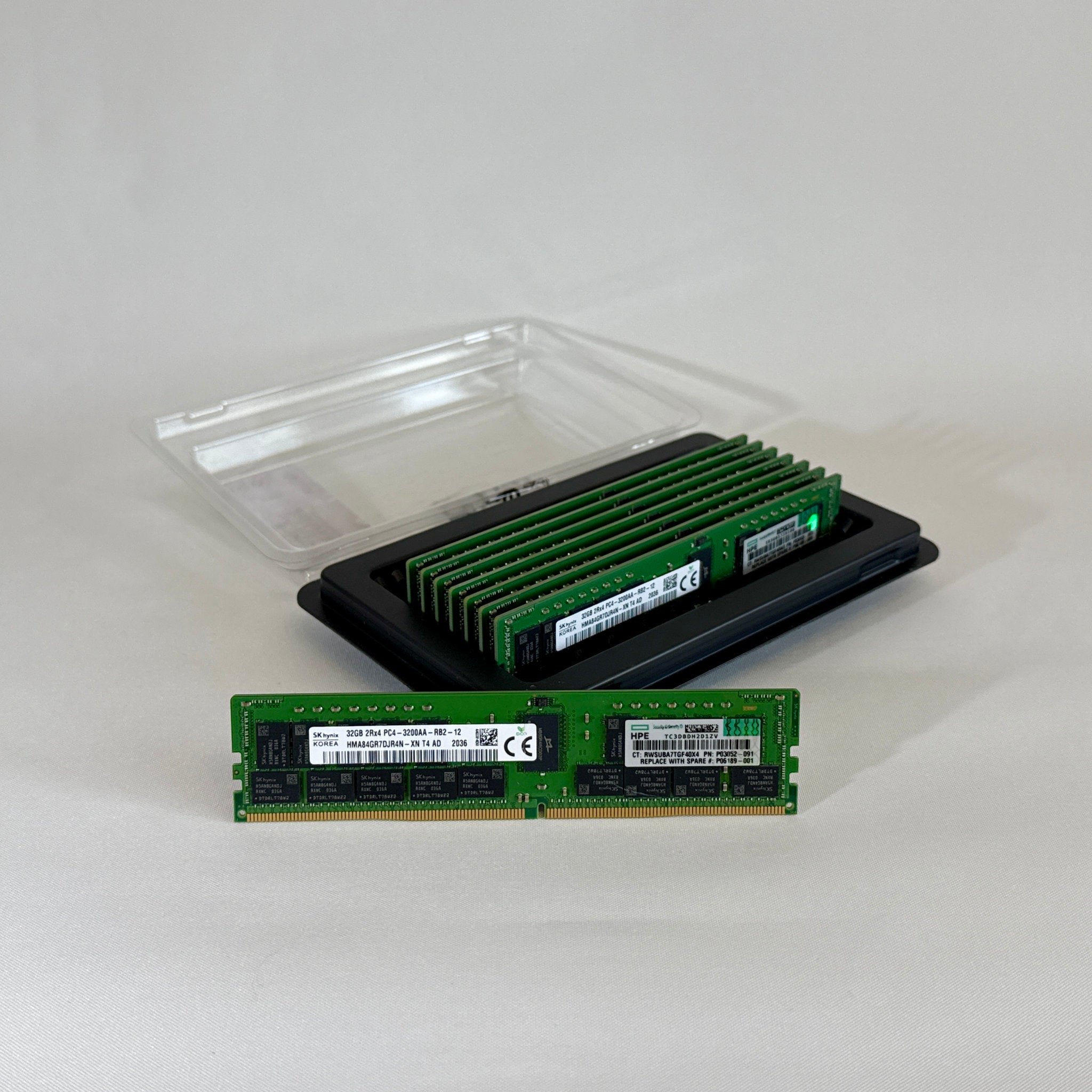 Front view of an SK Hynix 32GB 2Rx4 PC4-32AA DDR4 Registered ECC server memory stick. The green PCB holds the black memory chips and a clear white manufacturer label displaying the part number HMA84GR7DJR4N-XN and specifications.